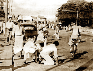 Riots May 1958 - A Tamil passenger was taken out of the vehicle and beaten up. Photo courtesy of Victor Ivan